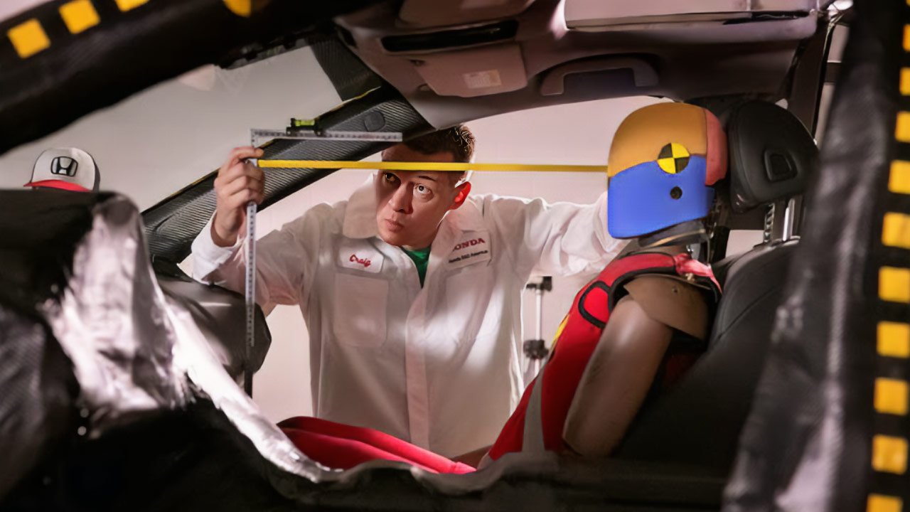 A Honda employee taking measurements inside a test vehicle.